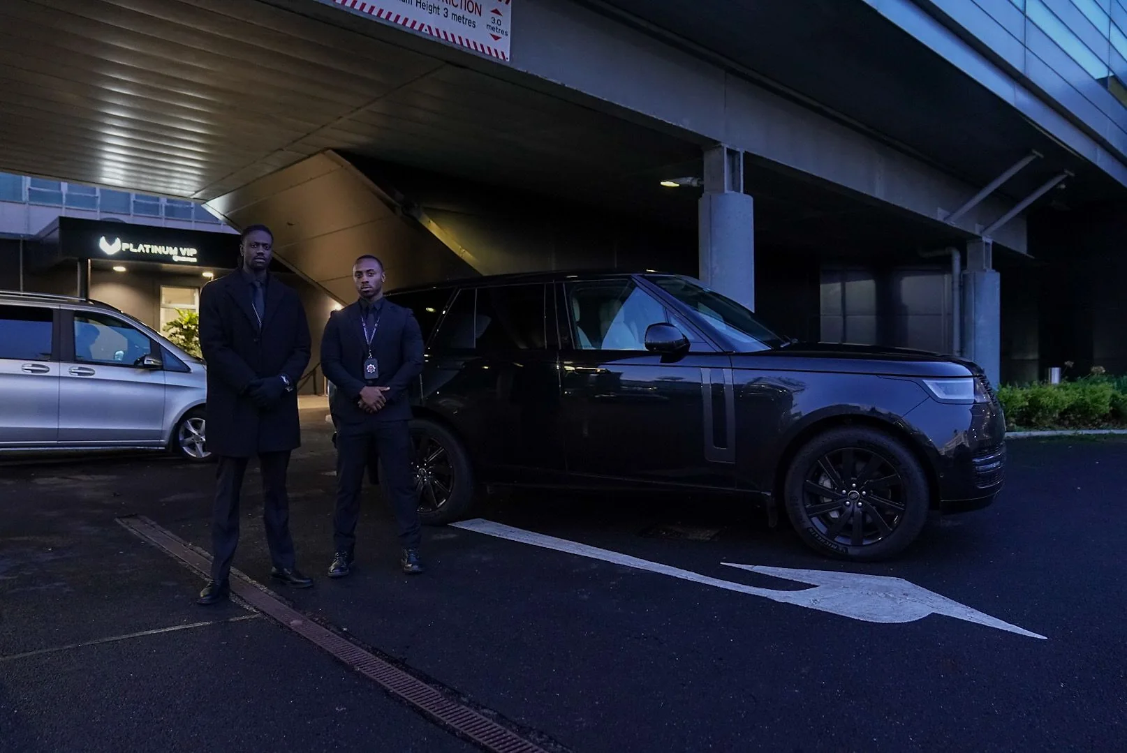 Spartan team beside an executive vehicle outside a hotel